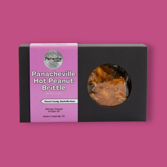 Box of Panacheville Hot Peanut Brittle on a pink background